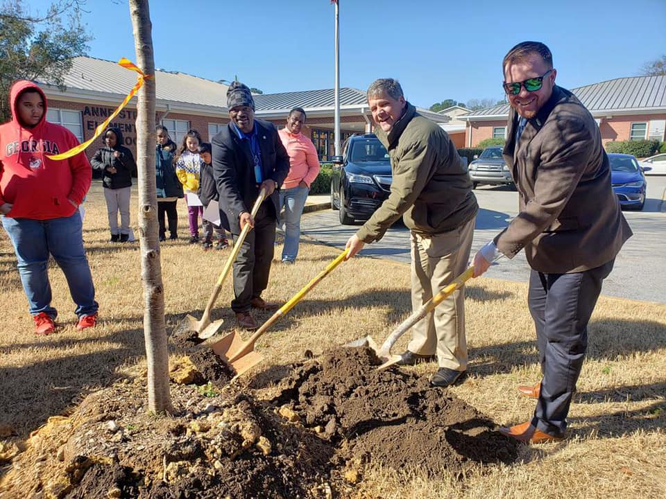 Griffin Mayor Doug Hollberg lends a hand to plant a new tree at on Arbor Day February 2023.